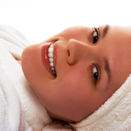 beauty girl in towel relaxing after shower on white background